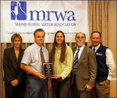 Winterport Water District accepting the Maine Rural Water Association's 2010 Small Systems Outstanding Water Operations Award at the 30th Annual Technical Conference, Exhibition and Meeting in Freeport on December 7th at the Hilton Garden Inn. Presenting the Award - Left to Right: Kirsten Hebert, MRWA Deputy Executive Director - Steven Lane, Superintendent Winterport Water District - Margaret Muller, Office Manager Winterport Water District - Steve Levy, MRWA Executive Director - Ron Boivin, MRWA Water Circuit Rider. 
